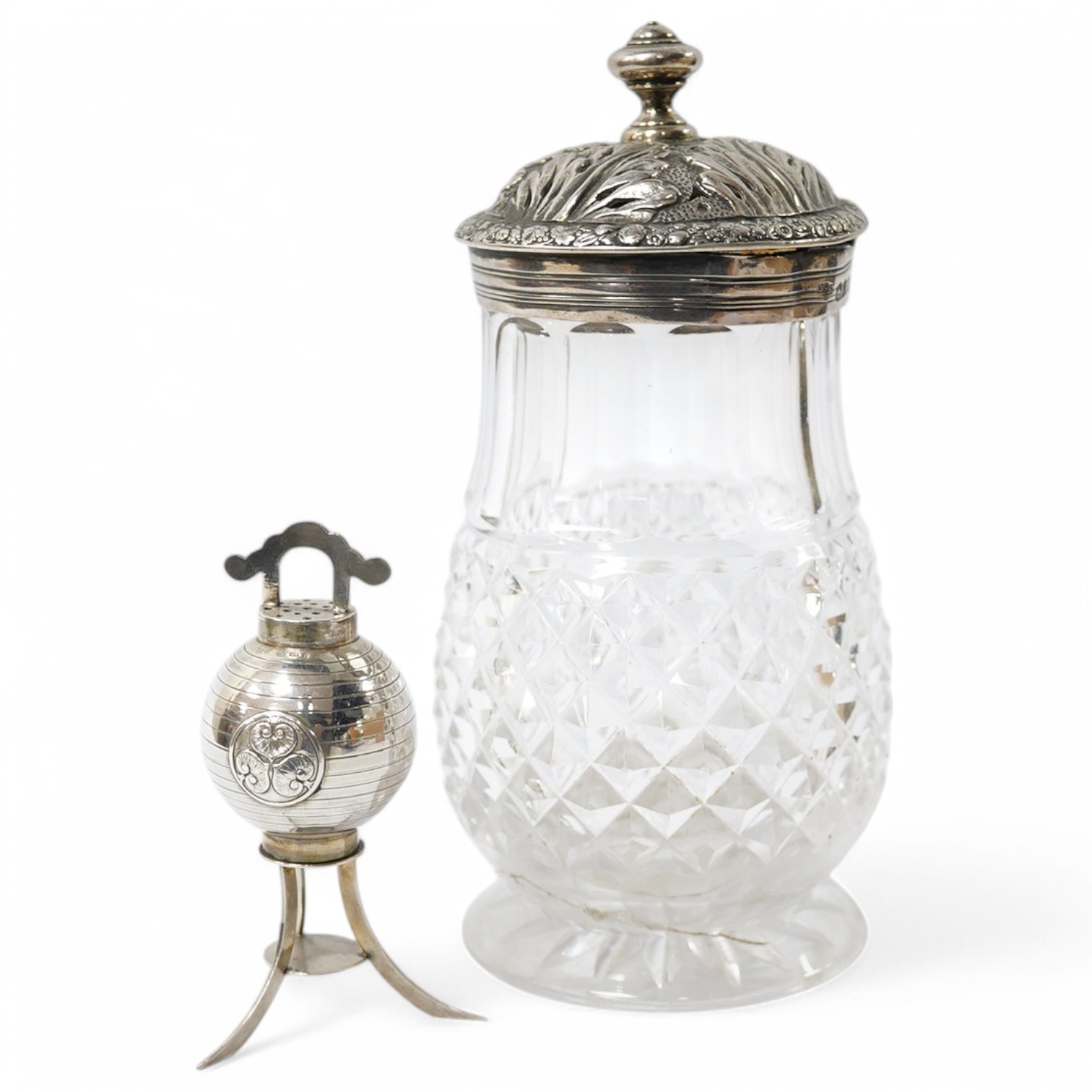 A Georgian silver mounted cut glass caster, London, 1818, 15.7cm, together with a Japanese silver condiment on tripod supports, import marks for Harrods Ltd, London, 1920. Condition - poor to fair